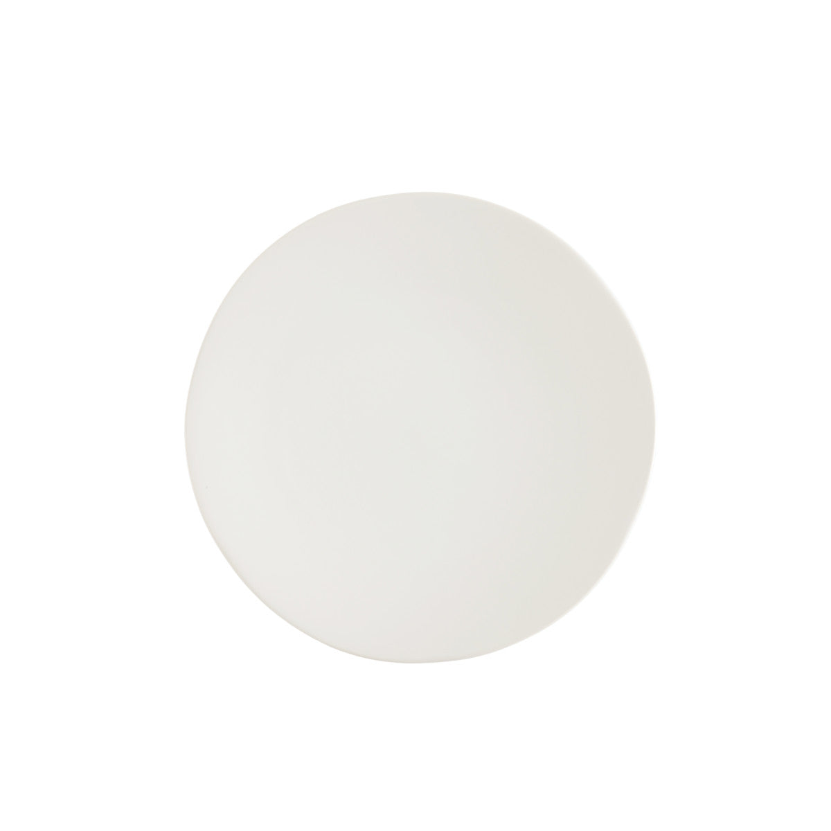 A round, white ceramic salad plate with a textured edge.
