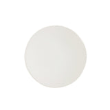A round, white ceramic salad plate with a textured edge.