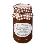A jar of Mrs. Darlington's Caramelised Onion Chutney with a checkered fabric on the lid.