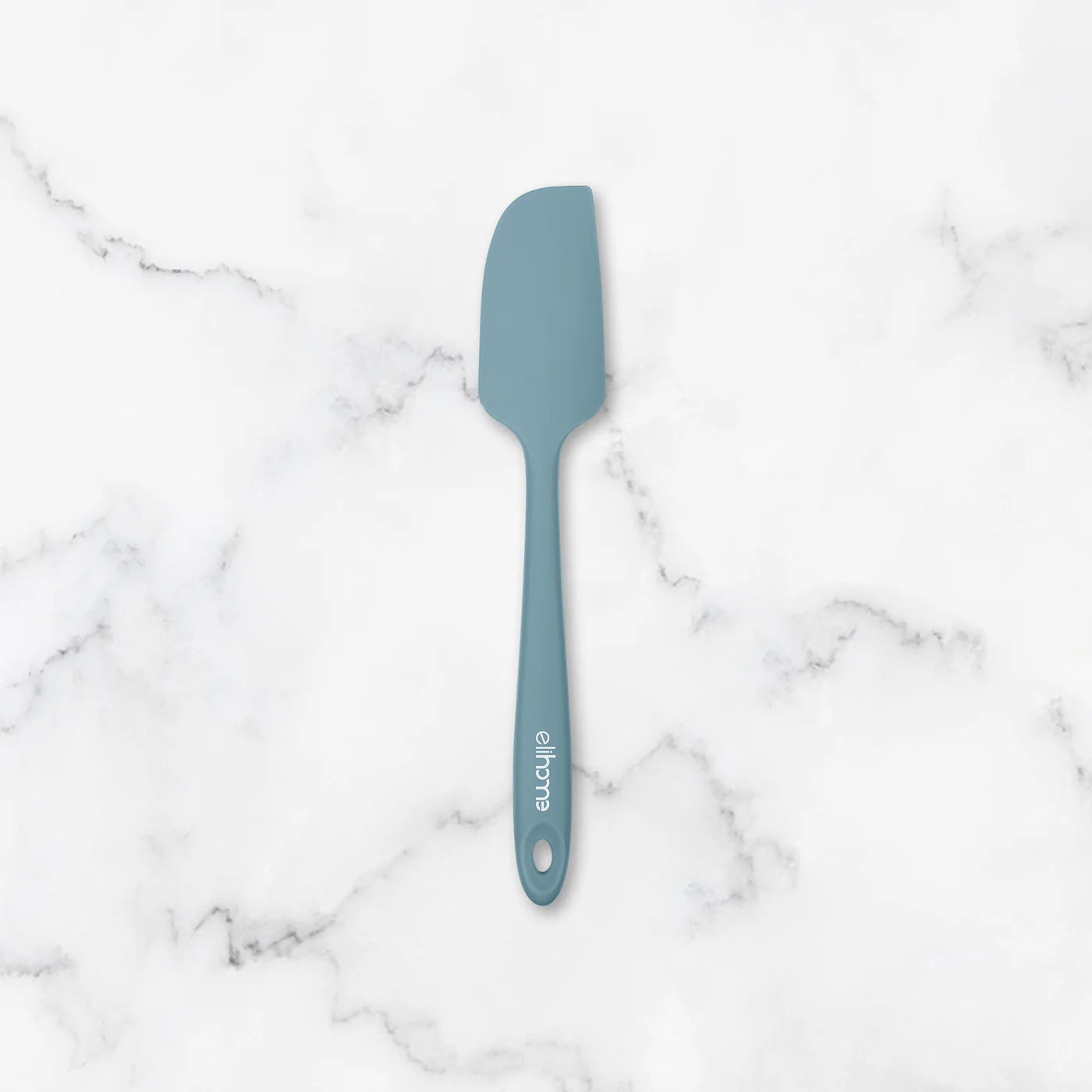 Blue spatula on a marble surface