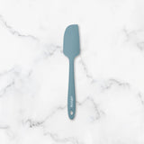 Blue spatula on a marble surface