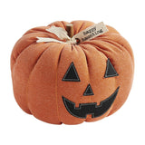 A plush orange pumpkin sitter with a happy face and the text 'happy haunting' on a tag.