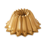 A gold-colored LOTUS BUNDT PAN with a unique fluted design for baking bundt cakes.