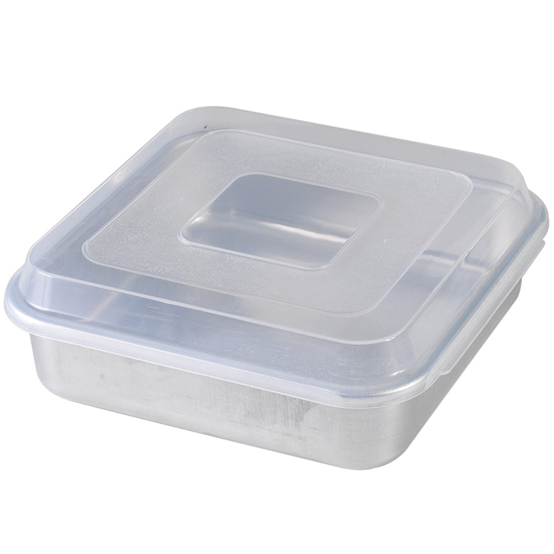 A square aluminum cake pan with a clear plastic lid.