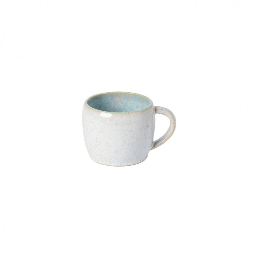 A white ceramic mug with a speckled pattern and a beige handle.