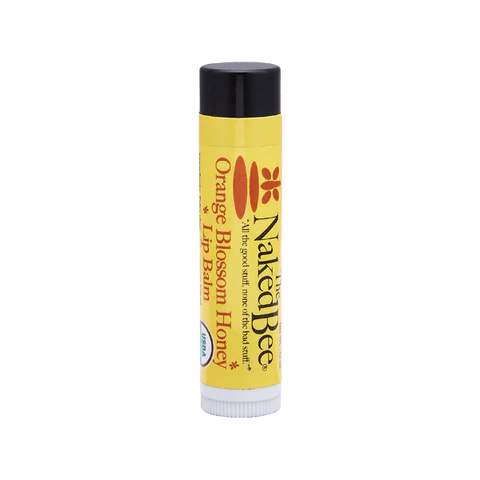 A tube of Naked Bee Lip Balm with orange and beeswax logos, indicating it is a lip balm with organic honey.