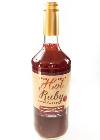 A bottle of Hot Ruby cranberry and citrus juice with a label indicating it is a product by Hot Ruby.