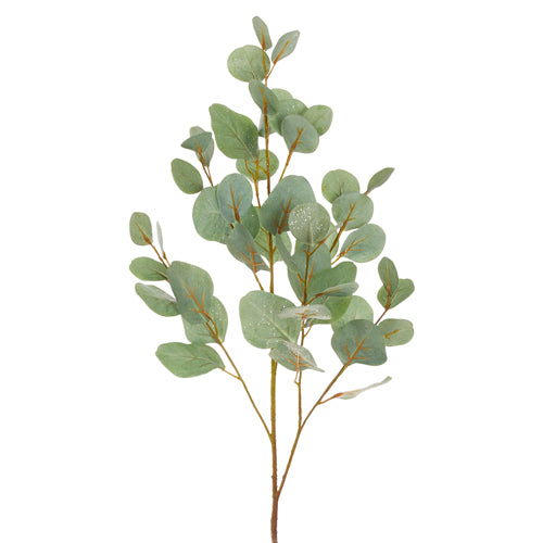 A glittered eucalyptus spray with green leaves and gold glitter accents on a stem, against a white background.