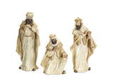 A set of three beige-colored figurines representing the Magi from the nativity story, dressed in traditional robes and kneeing or bowing.