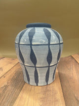 Blue vase with waves on wood table 