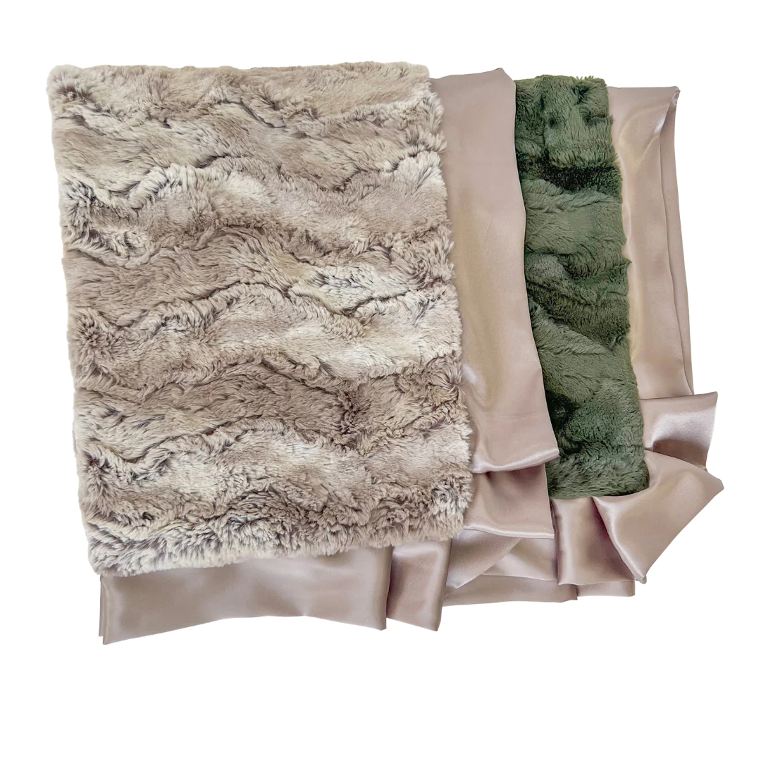 A baby blanket with a geometric pattern featuring beige, green, and brown colors.