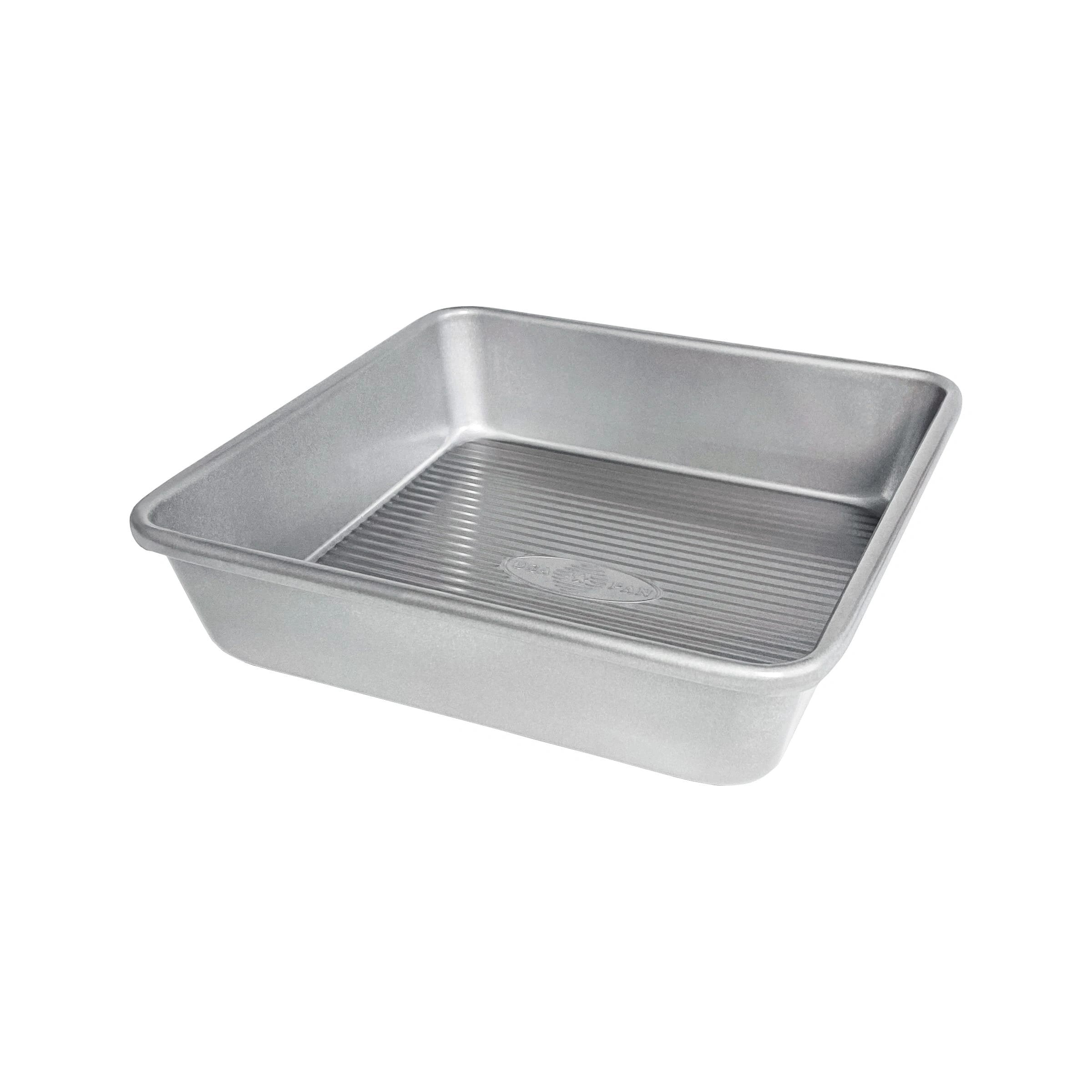 A silver square cake pan with a solid pattern and slightly raised edges.