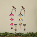 Two solar lighted metal and glass stakes with bird designs and colorful flower-like patterns, displayed against a neutral background with foliage at the bottom.