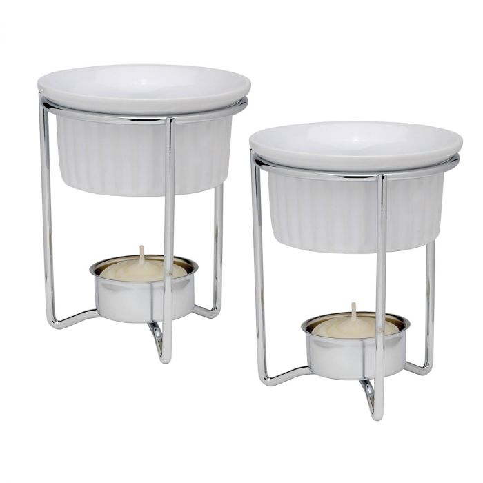 A set of two ceramic butter warmers with silver metal stands and white candle holders.