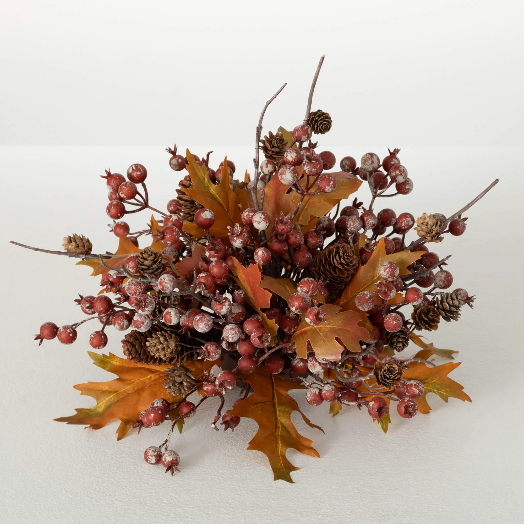 A decorative fall-themed berry leaf orb with orange leaves and multicolored berries.