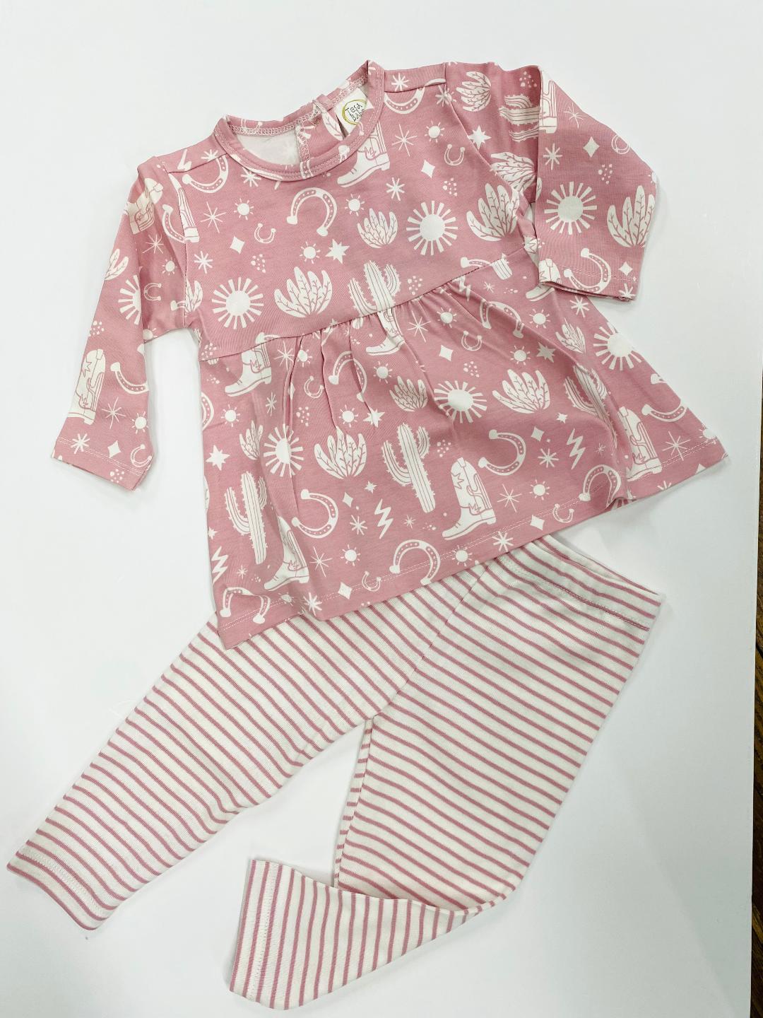 Children's two-piece outfit with a pink top featuring cactus patterns and striped leggings, laid flat on a white background.