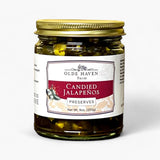 A jar of Olde Haven Farm Candied Jalapeños Preserves with a gold metal lid and a white label featuring a red banner, set against a plain white background.