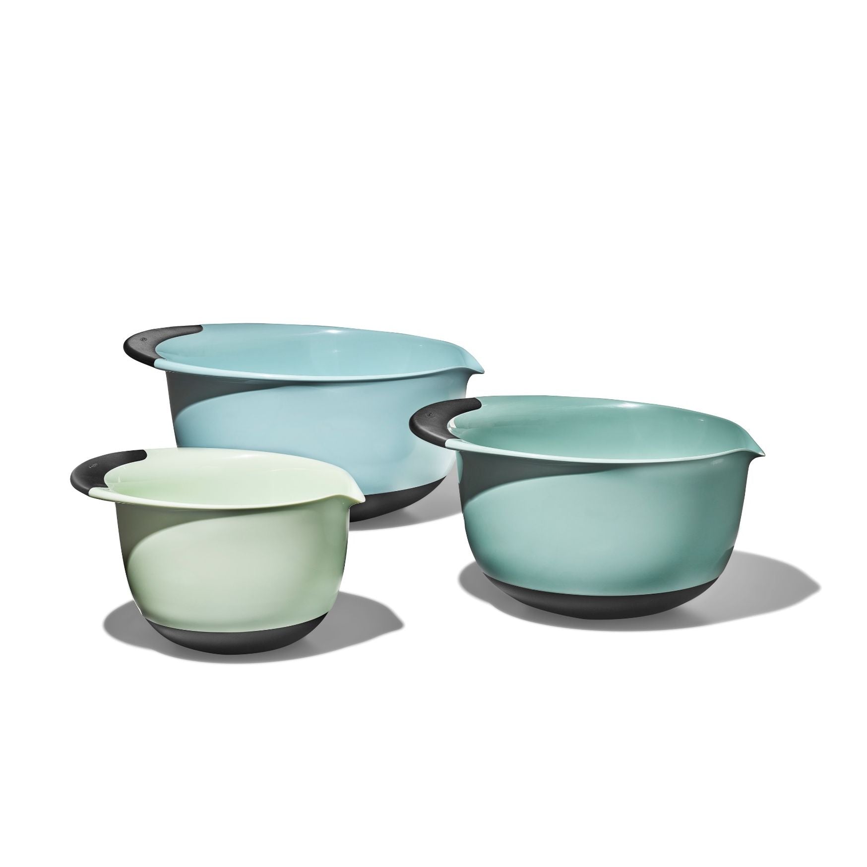 A set of three OXO mixing bowls in shades of blue and gray, with non-slip bases.