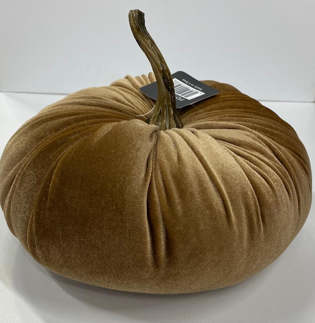 A decorative orange velvet pumpkin with a realistic stem on a white background.