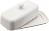 A white ceramic butter dish with a lid.