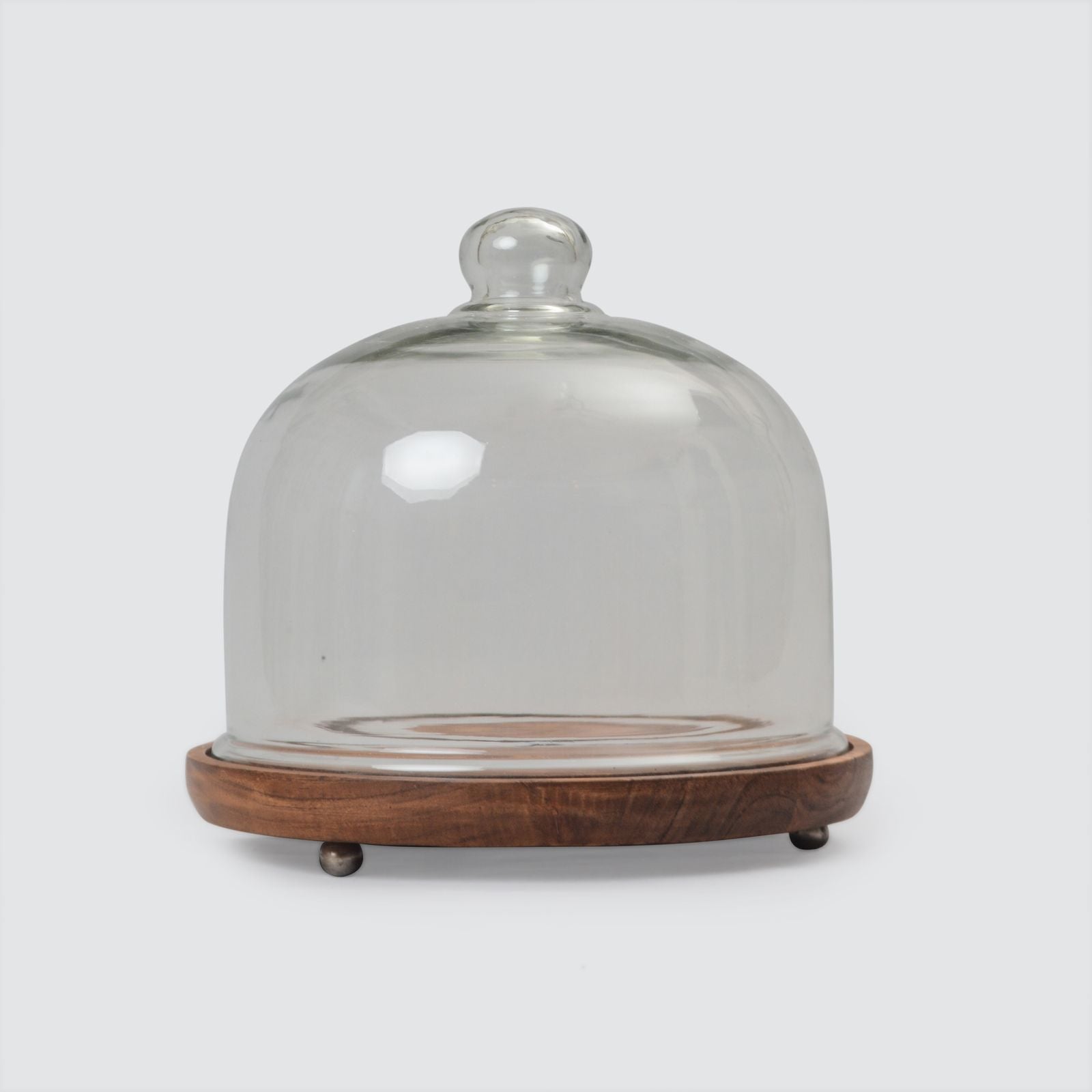 A clear glass cloche with a wooden base, featuring a solid wood top and a glass front.