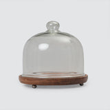 A clear glass cloche with a wooden base, featuring a solid wood top and a glass front.