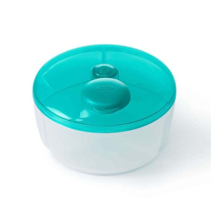A white OXO TOT formula dispenser with a blue lid, designed for baby bottle feeding.