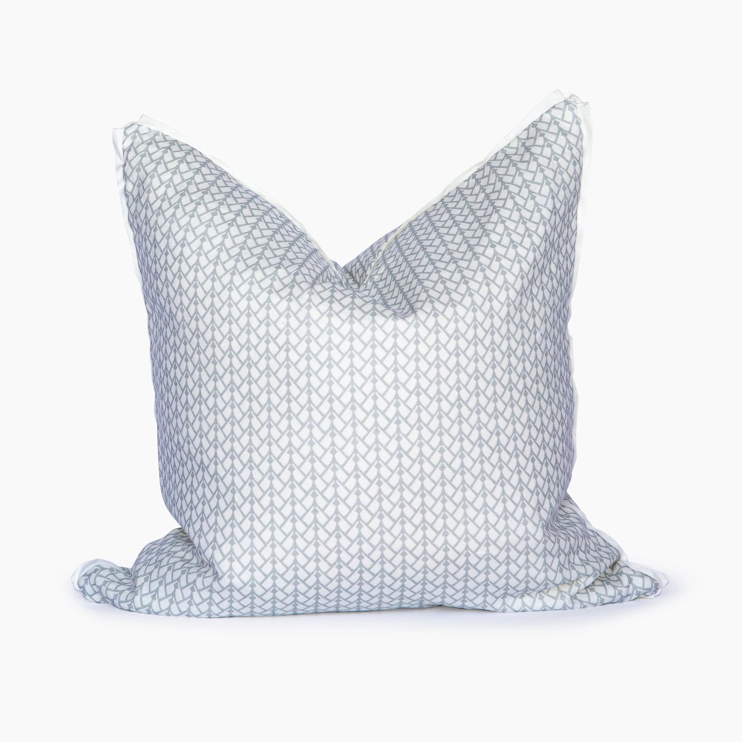 A white pillow with a geometric pattern.