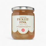 A glass jar of Natural Pickled Pink Spiced Watermelon Pickles with a silver metal lid and a cream-colored label, set against a plain white background.