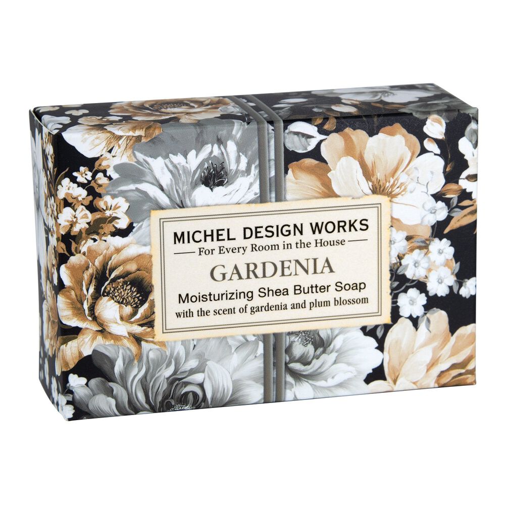A bar of soap with a floral pattern, packaged in a box with a floral design and the brand 'Michel Design Works' printed on it.