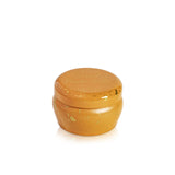 Yellow ceramic jar with speckled pattern on a white background