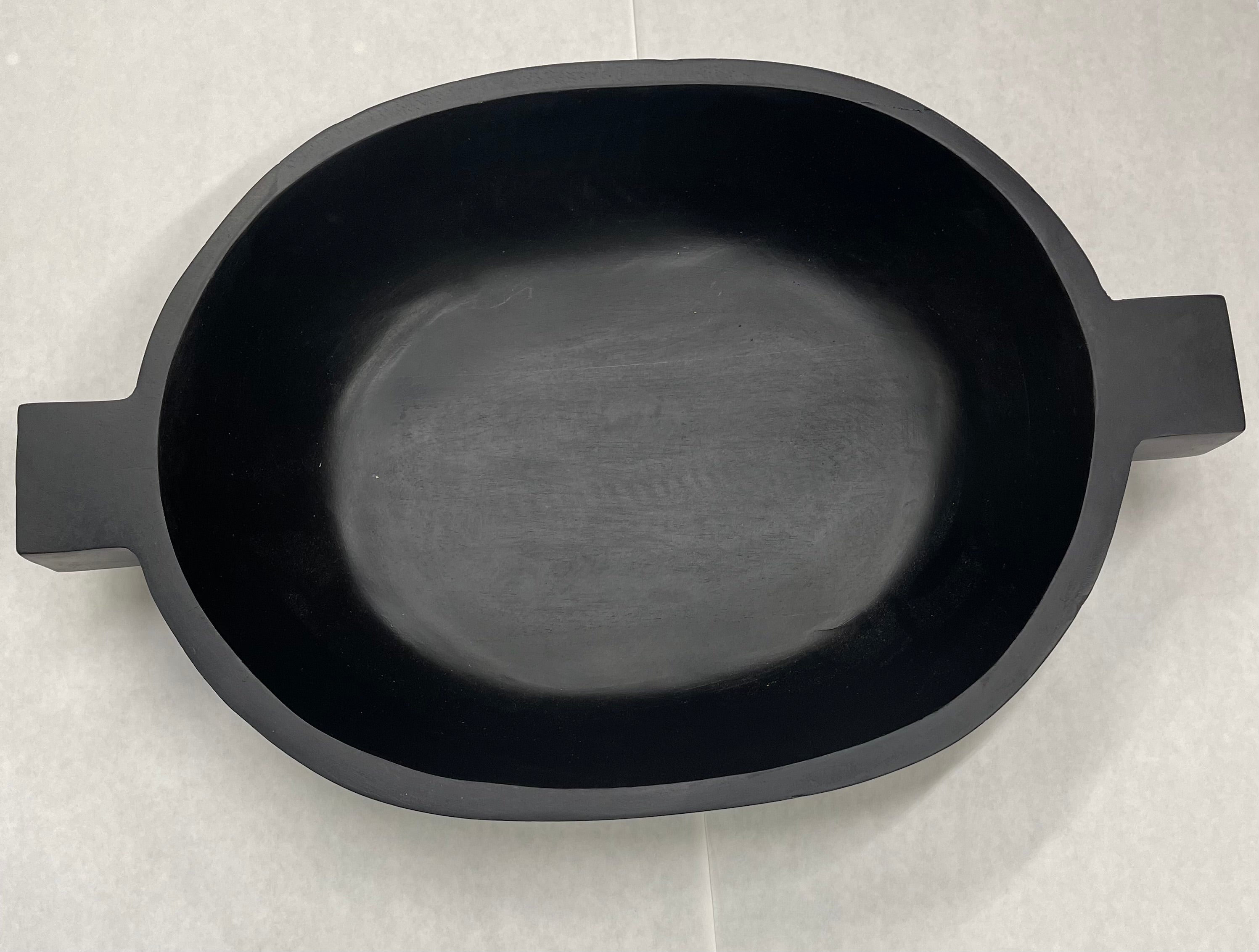 An 18.5 inch black wooden bowl with a handle on each side.