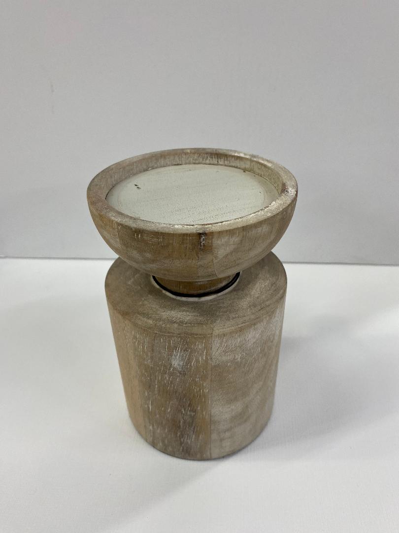 A two-tiered white wash wood candleholder with a cylindrical base and a bowl-shaped holder on top.