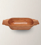 An oblong acacia wood bowl with handles on the sides, displayed against a neutral background.