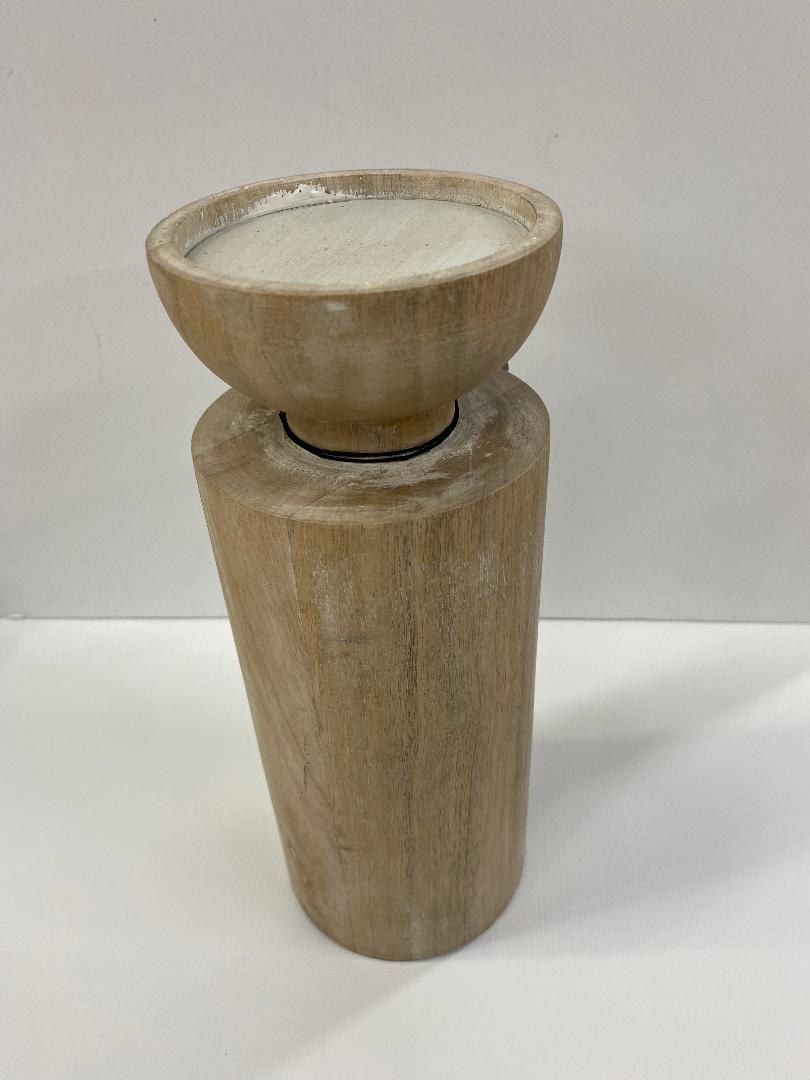 A two-tiered white wash wood candleholder with a cylindrical base and a bowl-shaped holder on top.