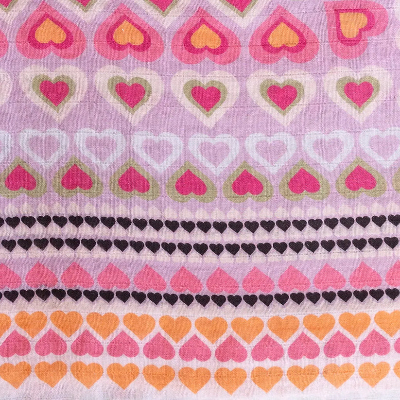 A swaddle blanket with a pattern of colorful hearts in shades of pink, purple, and orange.