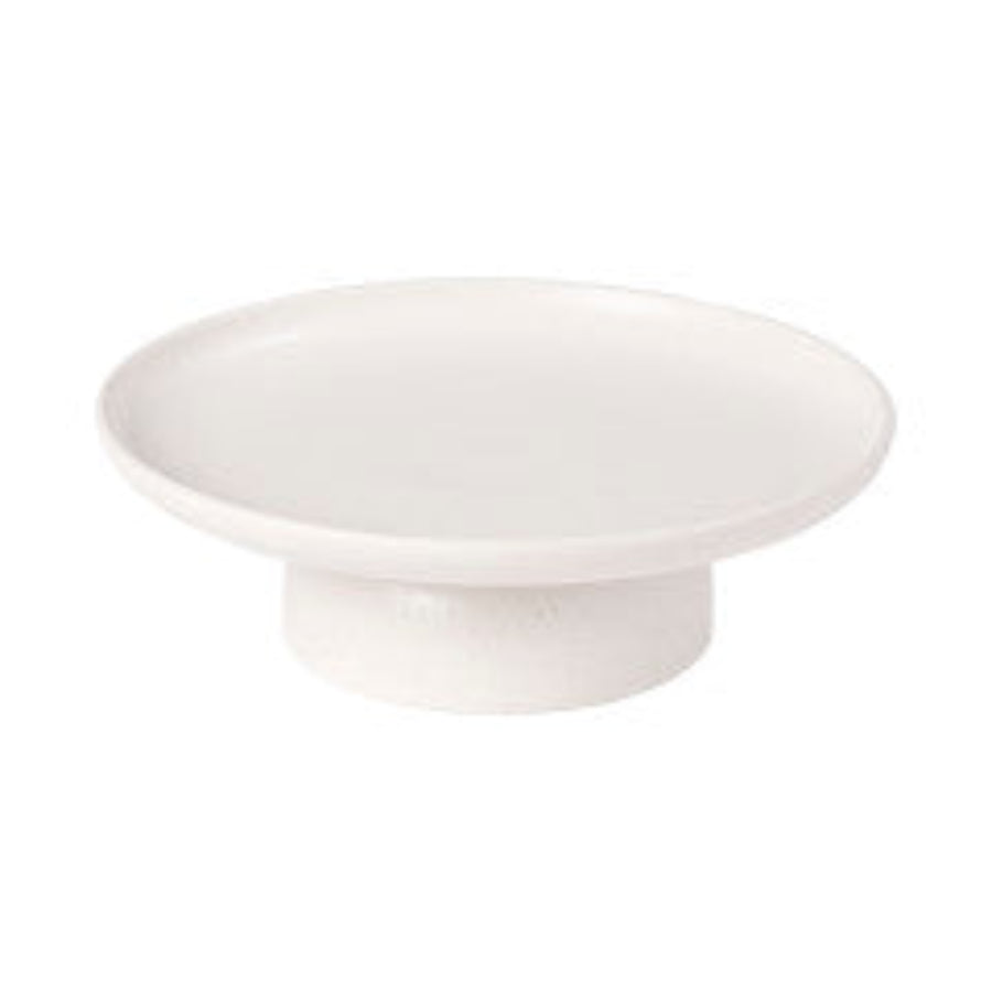 A white ceramic cake stand with a simple and elegant design.