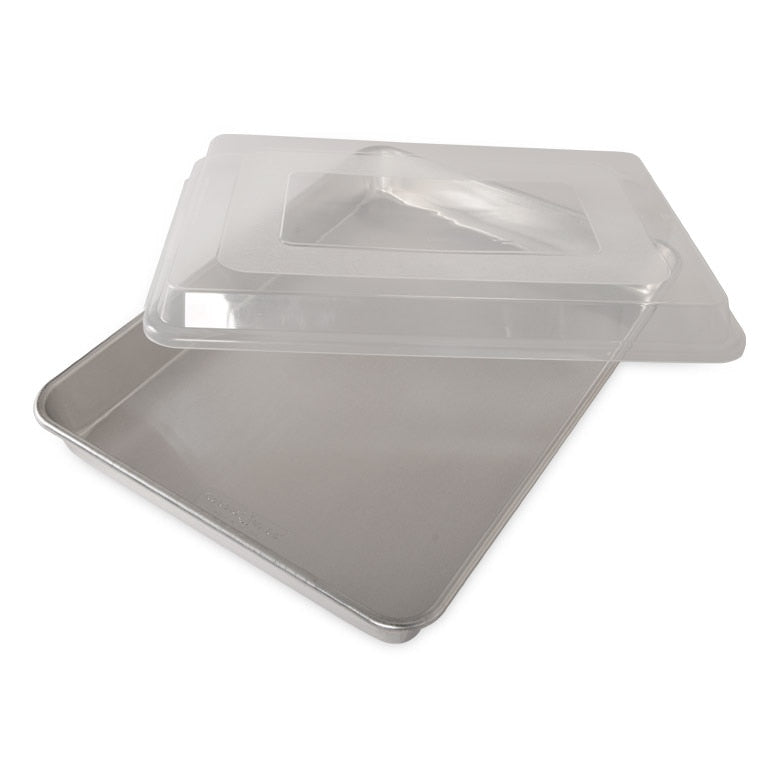 A clear, high-sided sheet cake baking pan with a matching transparent lid.