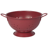 A matte carmine red colander with handles and a flat base for straining pasta or vegetables.