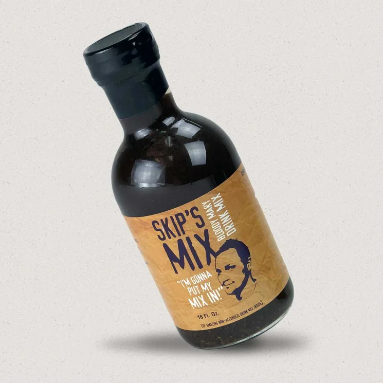A bottle of Skip's Mix, with a label featuring a man's face and the text 'Homemade bloody Mary mix'.