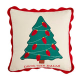 A Christmas-themed throw pillow with a green tree and red bulbs design, bordered in red, with the phrase 'DECK THE HALLS' on it.