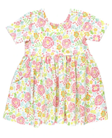 A sleeveless pink and green floral tank top with ruffled detailing.