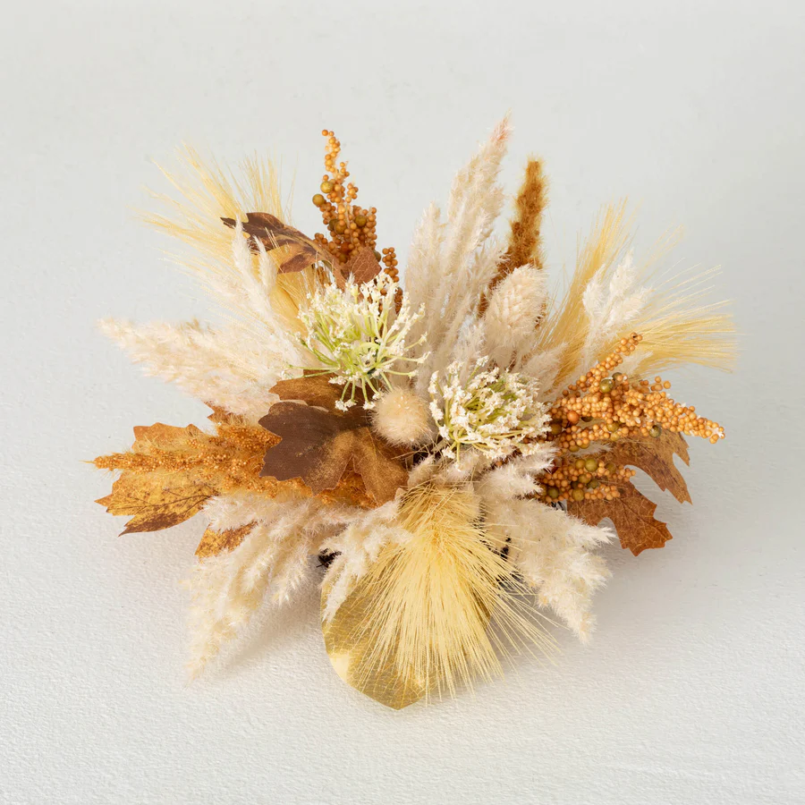 A dried floral arrangement featuring shades of beige, brown, and white, possibly representing a pampas orb with accompanying foliage.