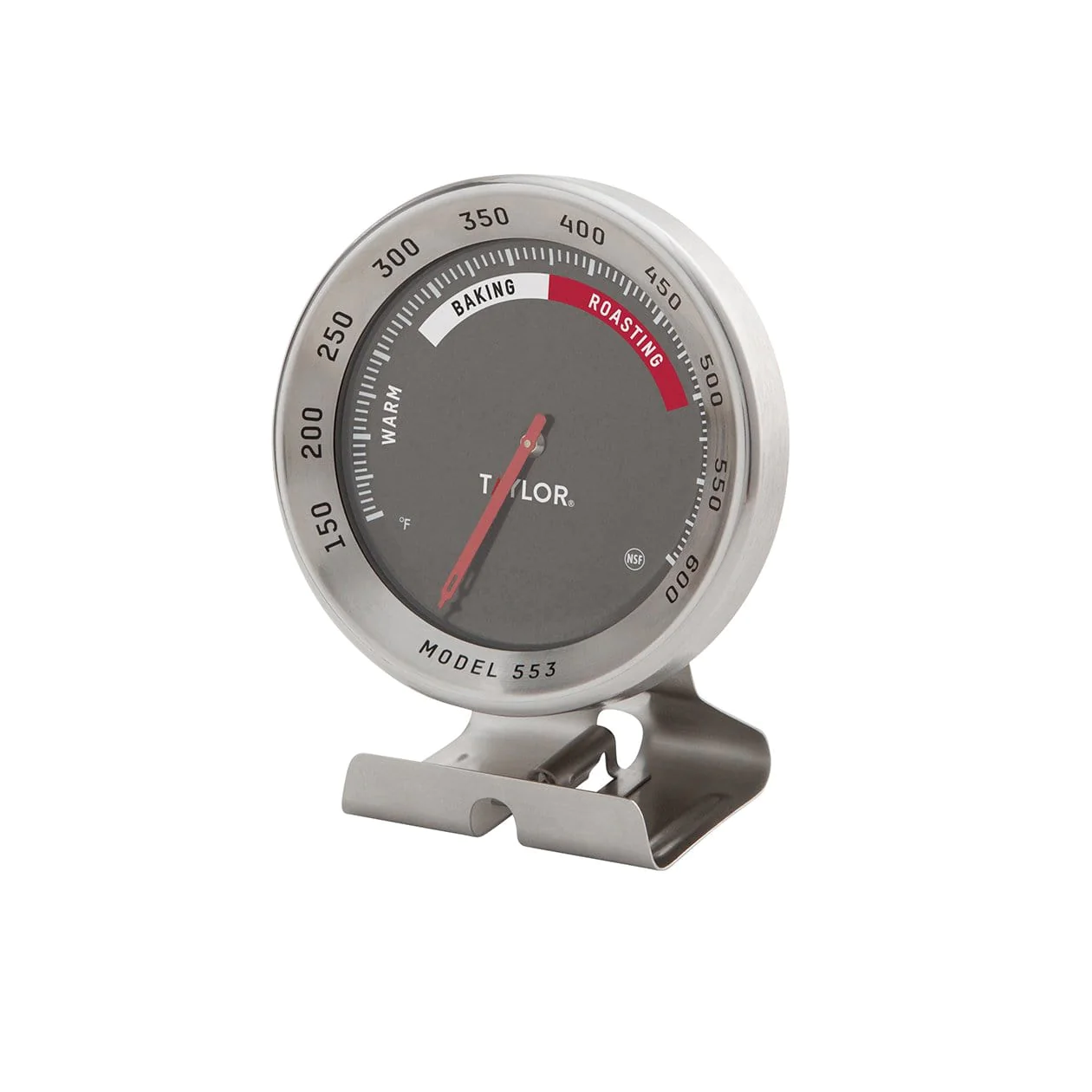 An analog oven thermometer with a dial marked with temperature readings, branded by Taylor. The thermometer is mounted on a stand and has a gray and silver color scheme.