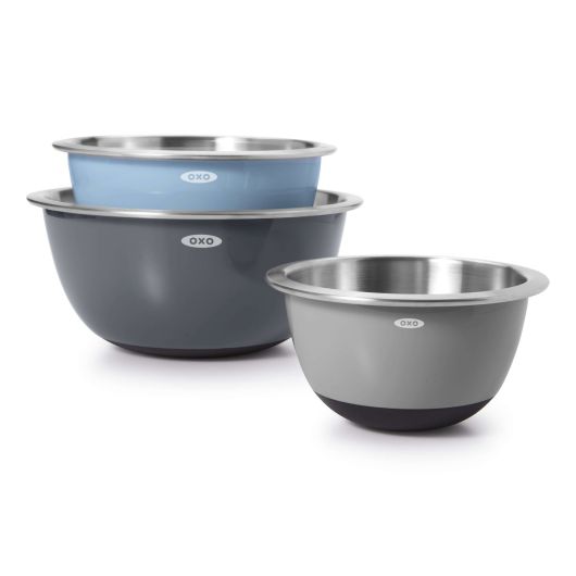 A set of three OXO mixing bowls in gray and blue colors, with the brand name visible on the labels.