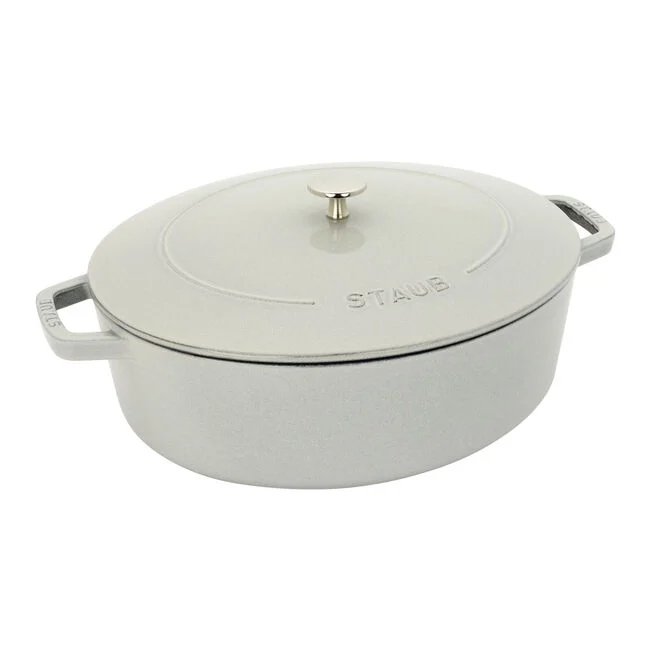 A silver STAUB cast iron Dutch oven with lid, featuring two handles and a knob on the lid for handling.