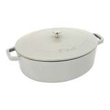 A silver STAUB cast iron Dutch oven with lid, featuring two handles and a knob on the lid for handling.