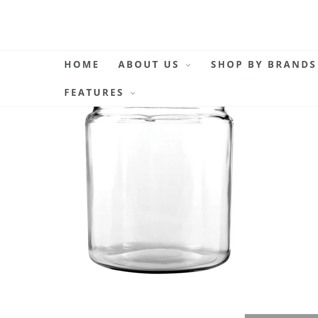 This image features the "HERIT HILL CANISTER 1/2 GAL," a transparent glass canister designed for versatile storage purposes. The canister boasts a simple yet elegant cylindrical shape with smooth surfaces, highlighting its sleek and minimalistic design.