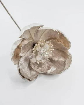 A metallic silver fabric flower accessory with a textured center and a thin wire stem, shown on a plain light gray background.