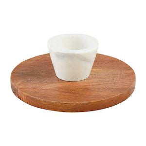 A wooden reverse pedestal chip and dip serving dish with a white cup on top.